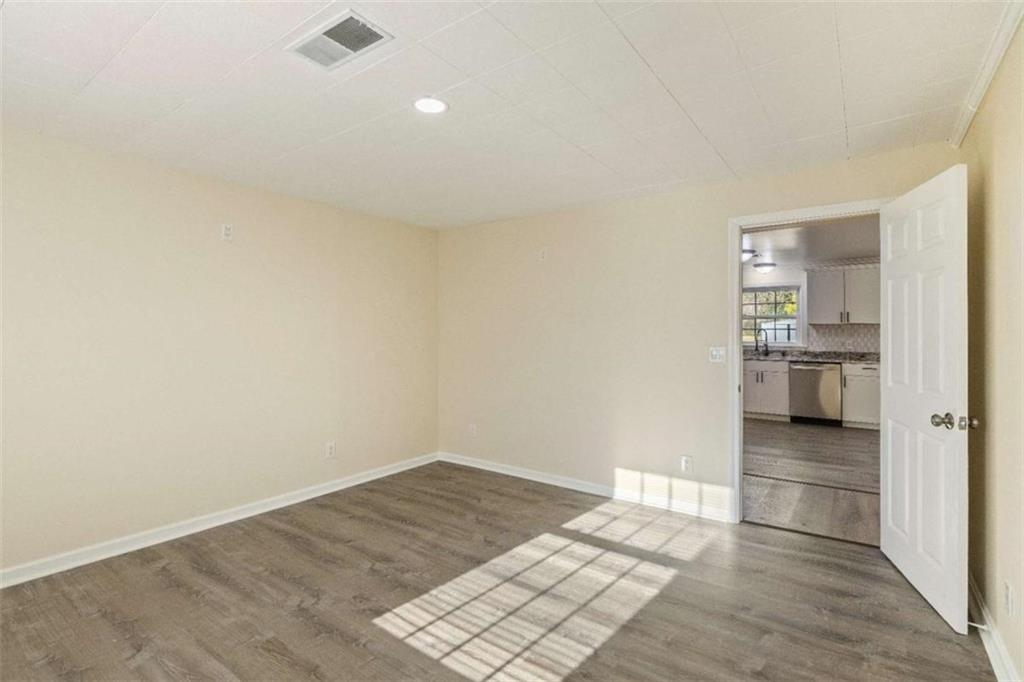 614 Burnett Ferry Road Southwest Rome, GA 30165 - Photo 8 of 29 wooden floor in an empty room and a kitchen