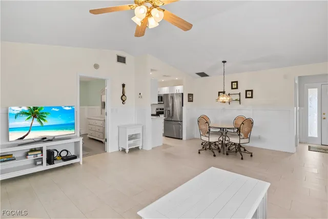 a dining room with furniture and kitchen view