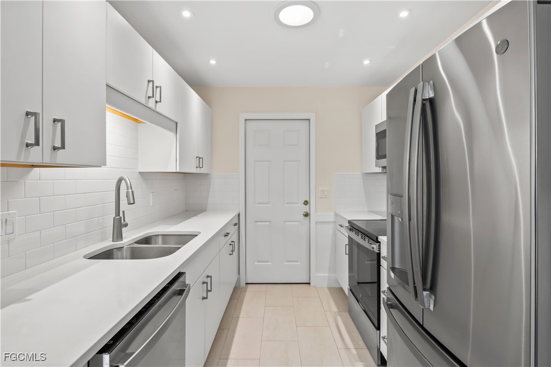 2781 Bruce Street Matlacha, FL 33993 - Photo 13 of 39 a kitchen with a sink stove and refrigerator