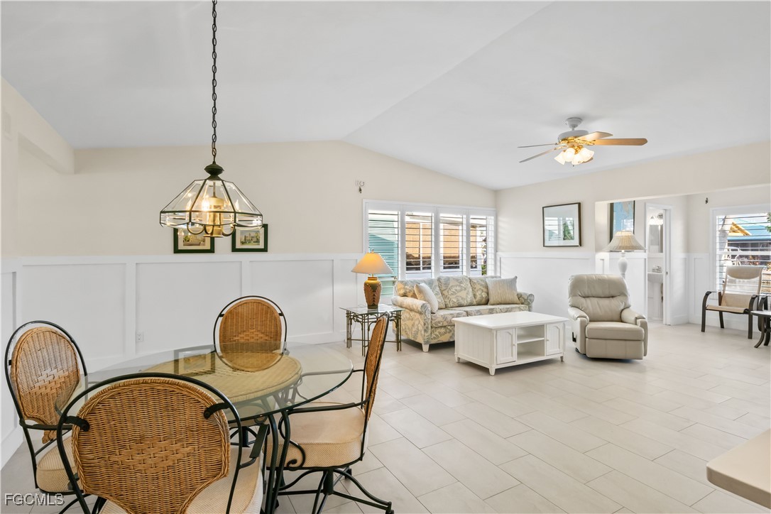 2781 Bruce Street Matlacha, FL 33993 - Photo 15 of 39 a living room with furniture a chandelier fan and a window