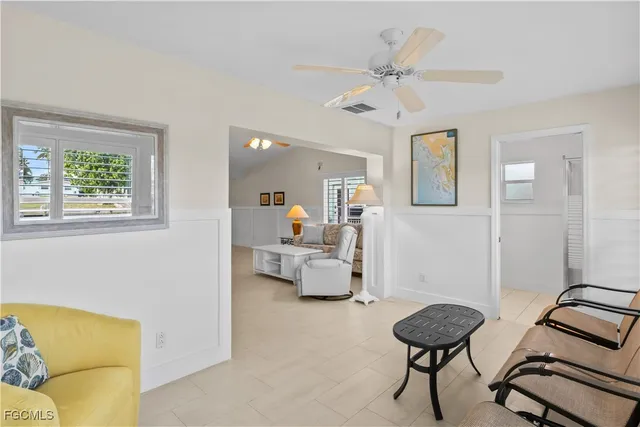a bedroom with a bed chandelier and a window