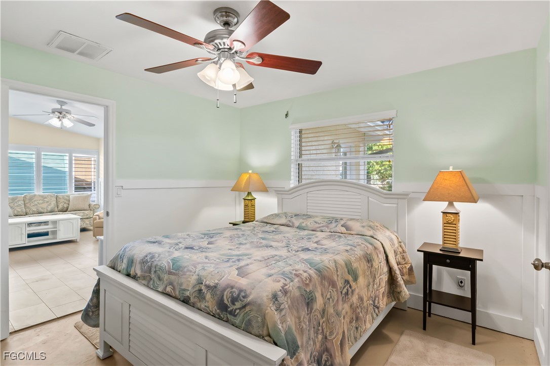 2781 Bruce Street Matlacha, FL 33993 - Photo 19 of 39 a bedroom with a bed chandelier and a window