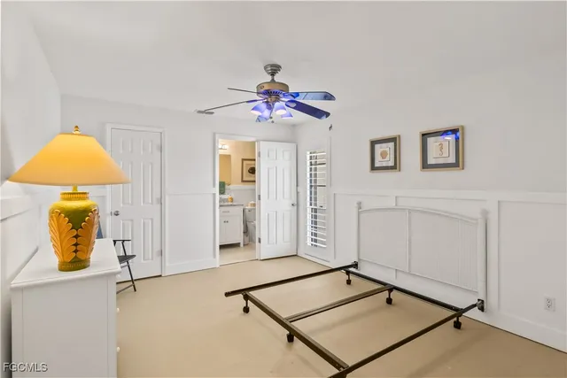 a bathroom with a granite countertop sink toilet a mirror a vanity and shower