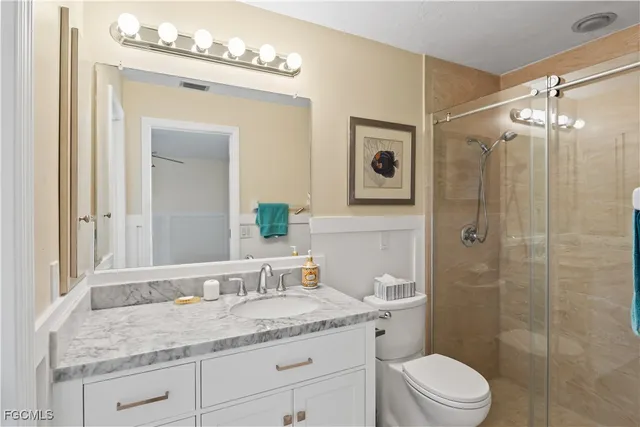 a bathroom with a sink toilet and shower