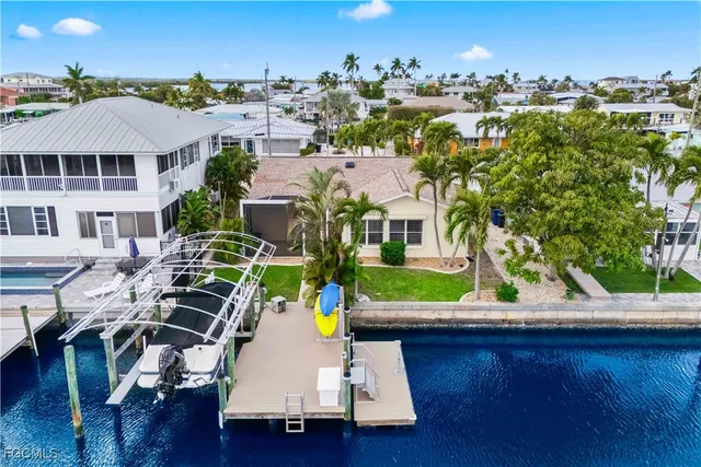 an aerial view of residential houses with outdoor space and street view