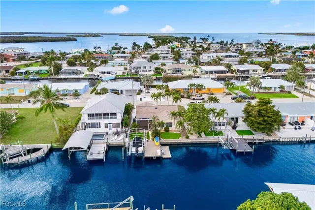 a aerial view of a house with a yard and trees