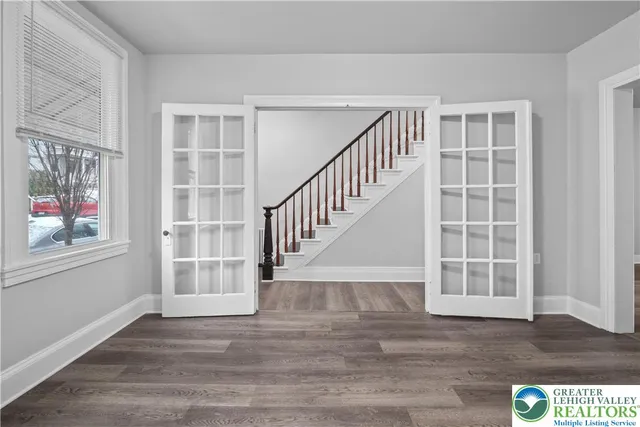 a view of an empty room with wooden floor