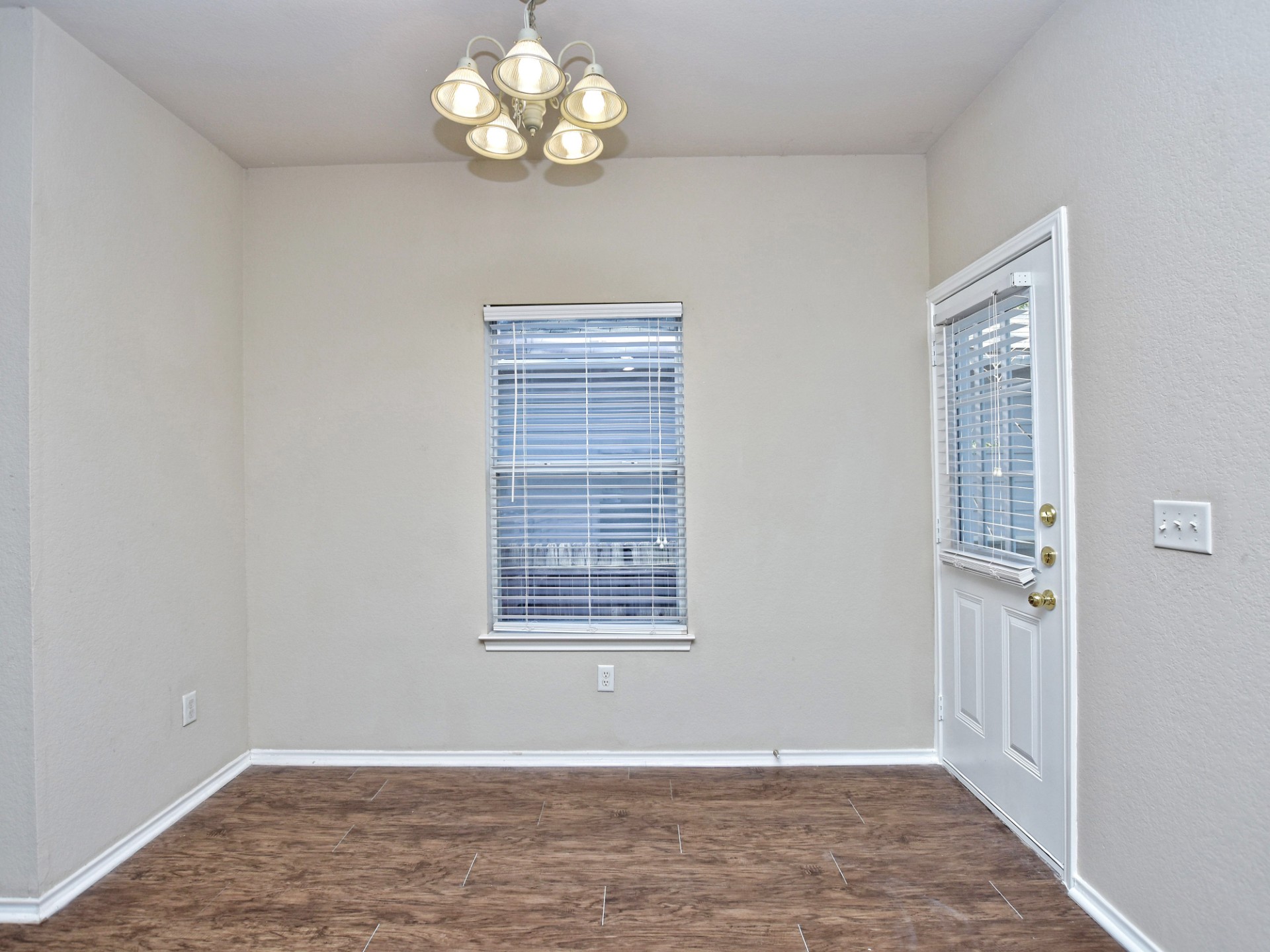 917 East 3rd Street Georgetown, TX 78626 - Photo 6 of 23 A versatile space features durable wood-look flooring, ready for personalization.