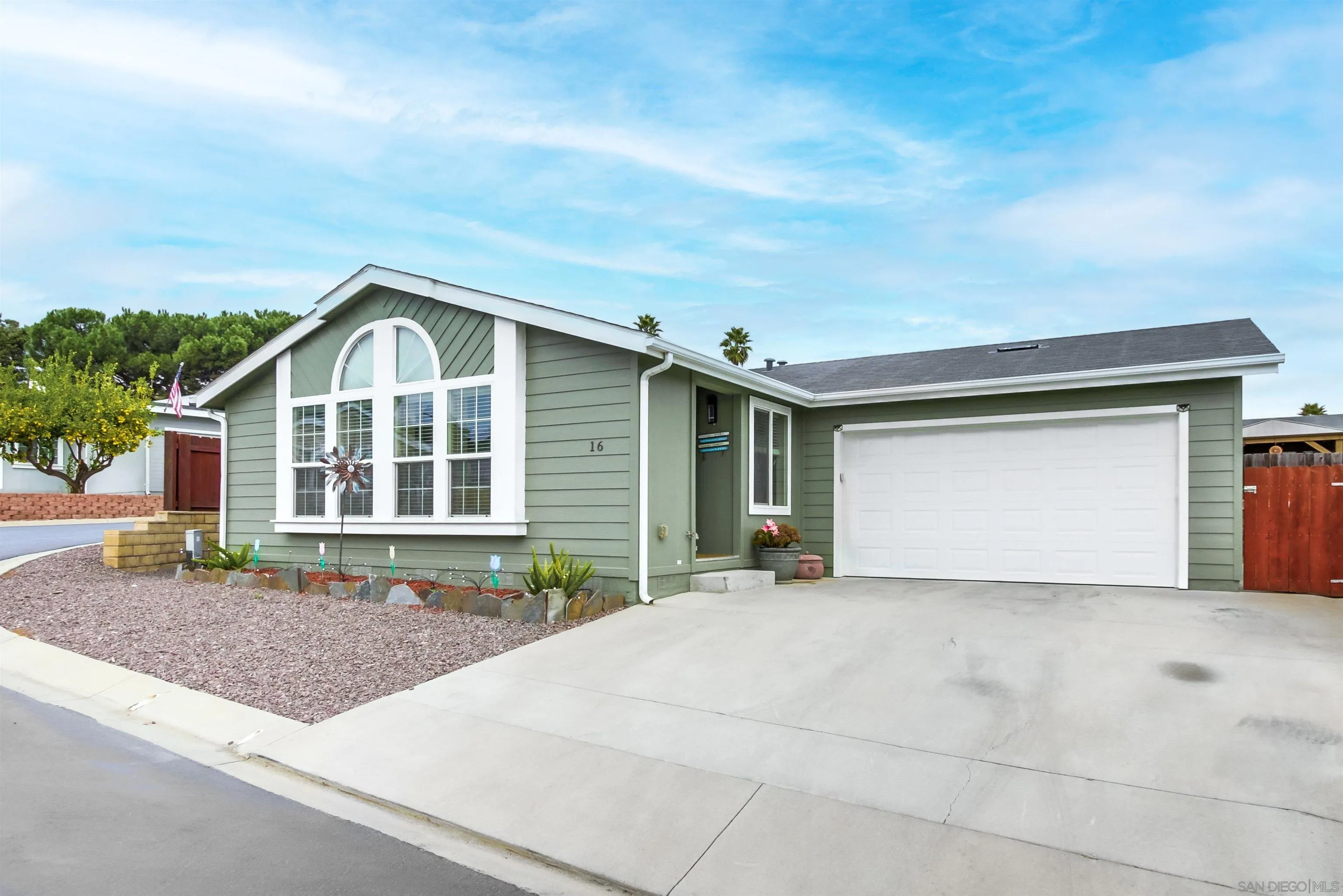 15935 Spring Oaks Road, Unit SPACE 16 El Cajon, CA 92021 - Photo 1 of 45 a front view of a house with a yard and garage