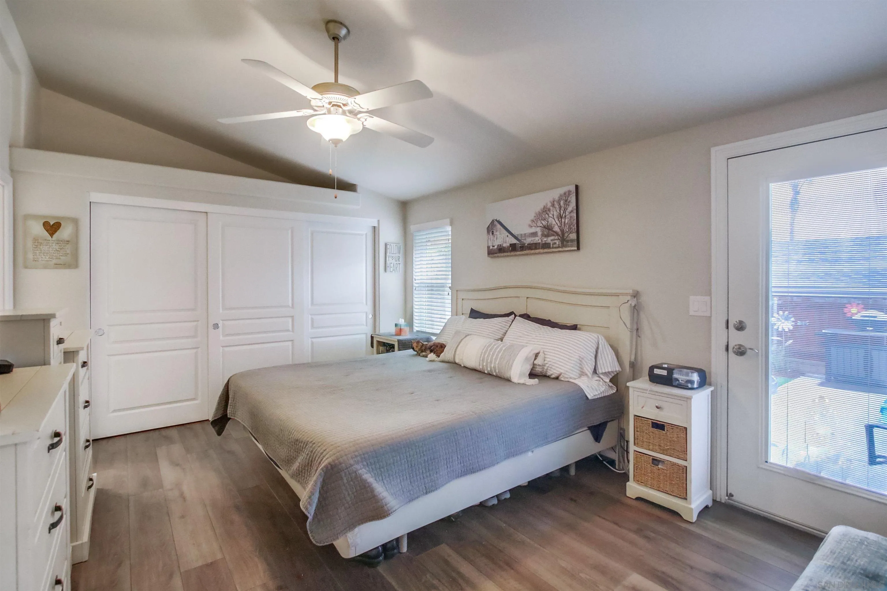 15935 Spring Oaks Road, Unit SPACE 16 El Cajon, CA 92021 - Photo 14 of 45 a bedroom with a large bed and a ceiling fan