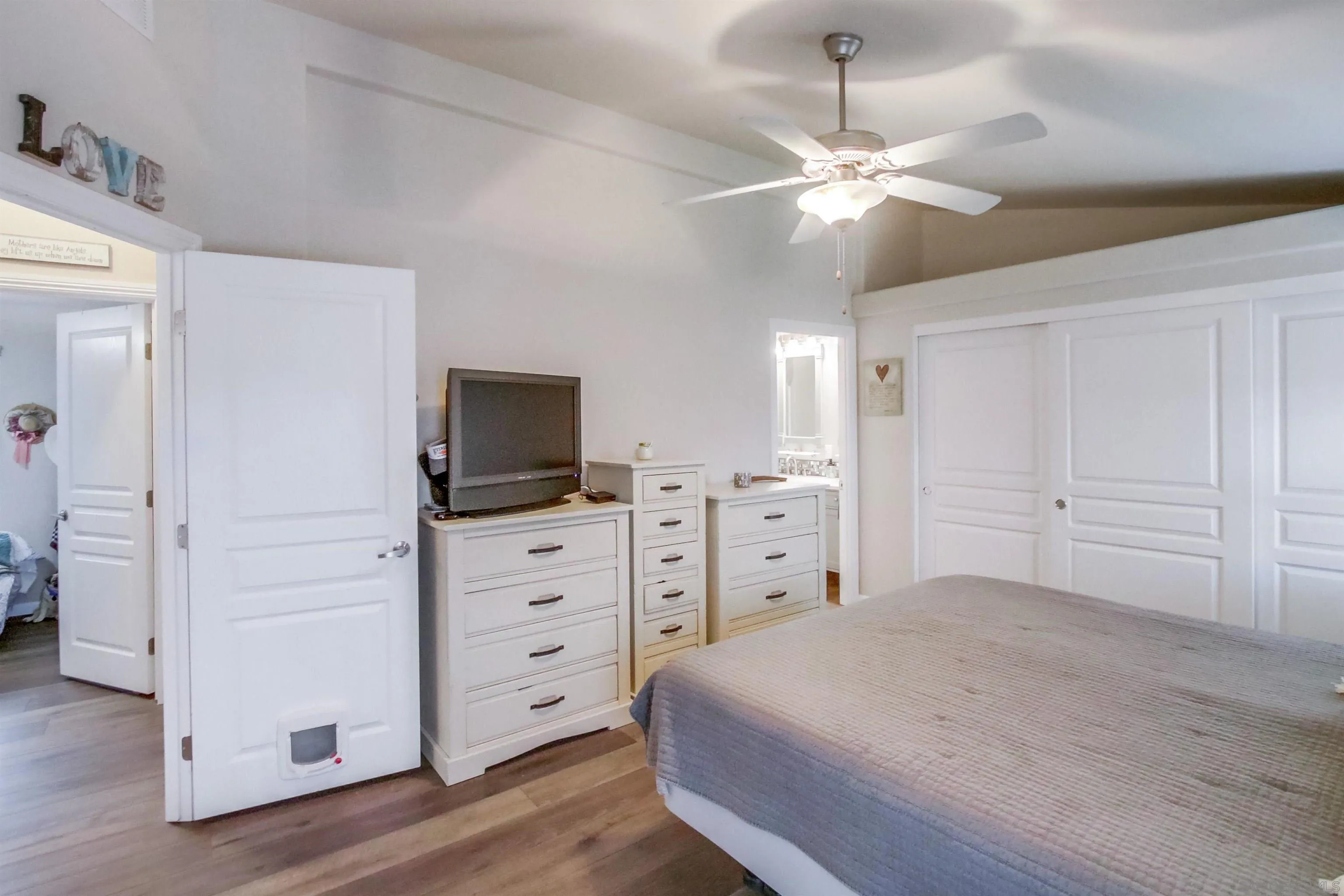 15935 Spring Oaks Road, Unit SPACE 16 El Cajon, CA 92021 - Photo 15 of 45 a bedroom with a large bed and a flat tv screen on dresser