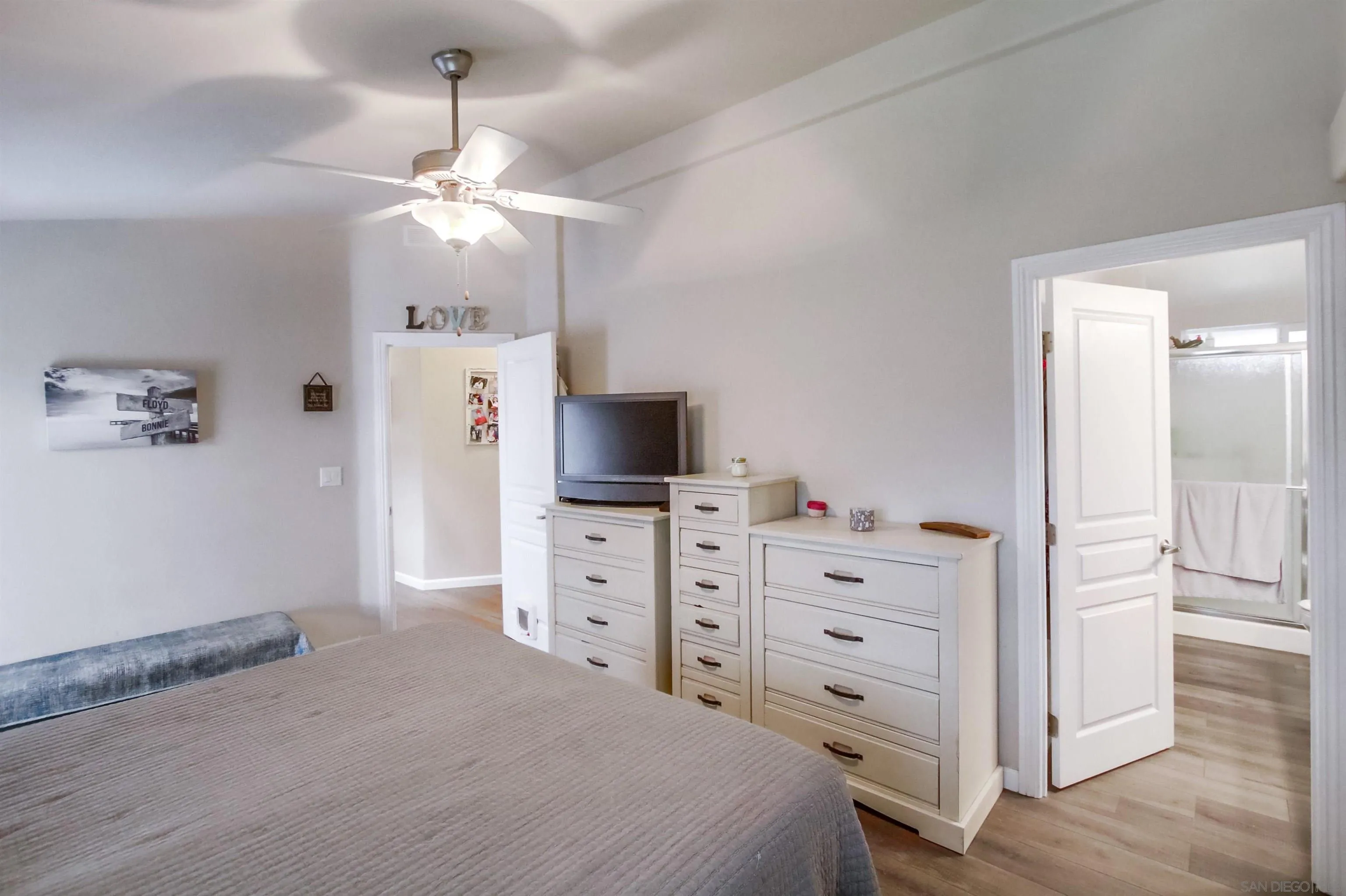 15935 Spring Oaks Road, Unit SPACE 16 El Cajon, CA 92021 - Photo 17 of 45 a bedroom with a dresser and a chandelier