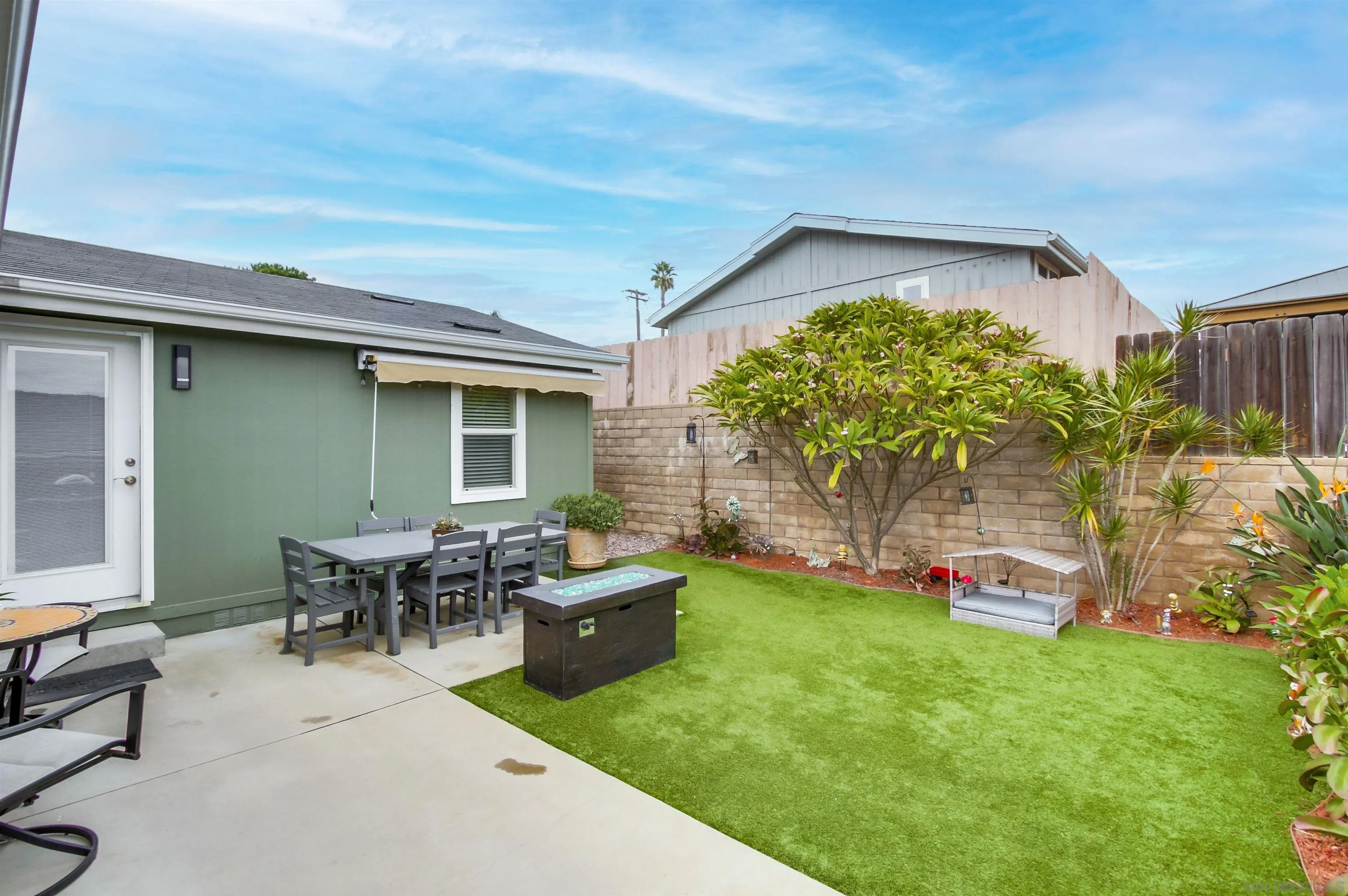 15935 Spring Oaks Road, Unit SPACE 16 El Cajon, CA 92021 - Photo 29 of 45 a backyard of a house with dining table and chairs with plants