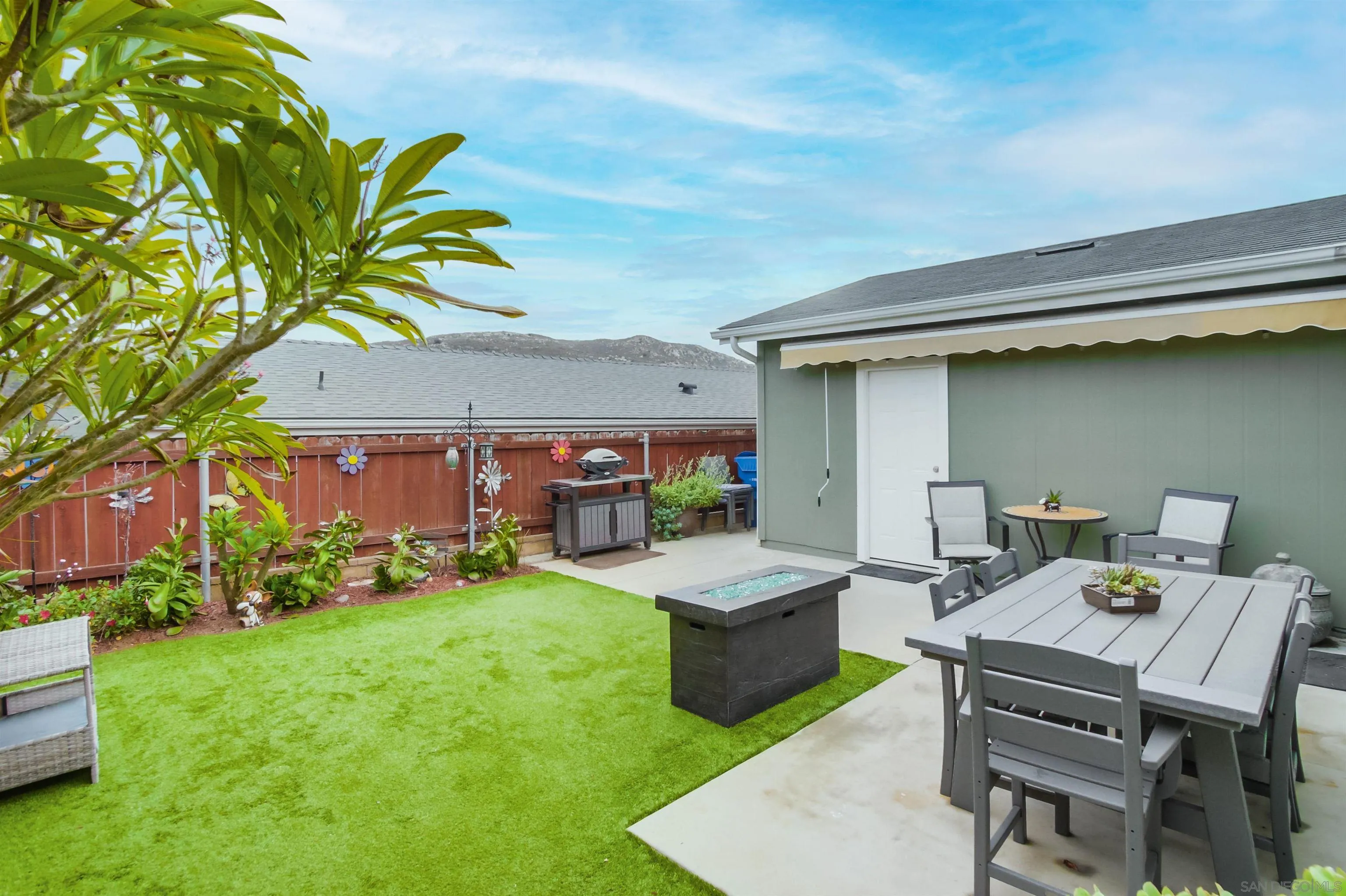 15935 Spring Oaks Road, Unit SPACE 16 El Cajon, CA 92021 - Photo 30 of 45 a view of a patio with table and chairs a barbeque with potted plants and big trees