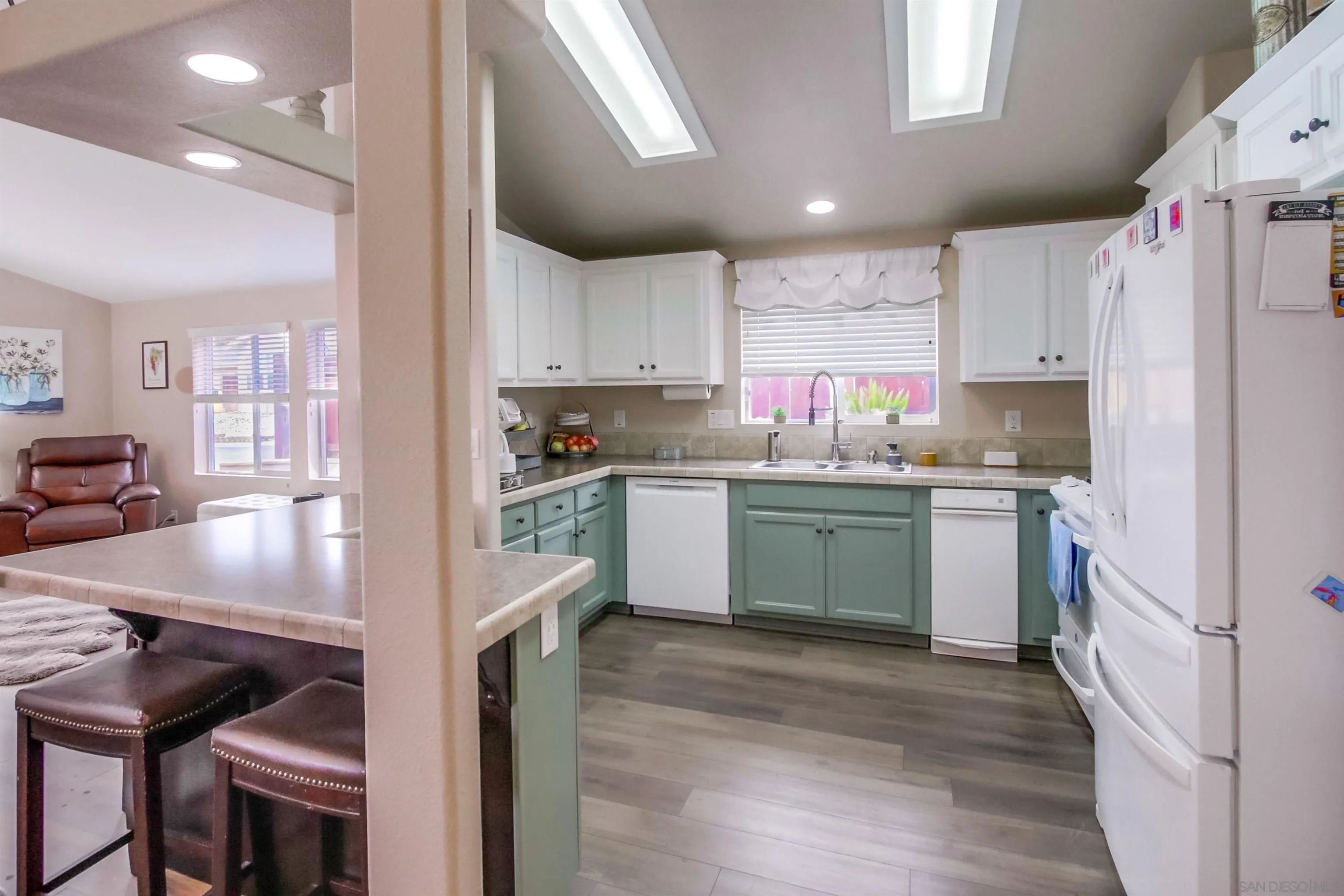15935 Spring Oaks Road, Unit SPACE 16 El Cajon, CA 92021 - Photo 9 of 45 a kitchen with a sink cabinets and wooden floor