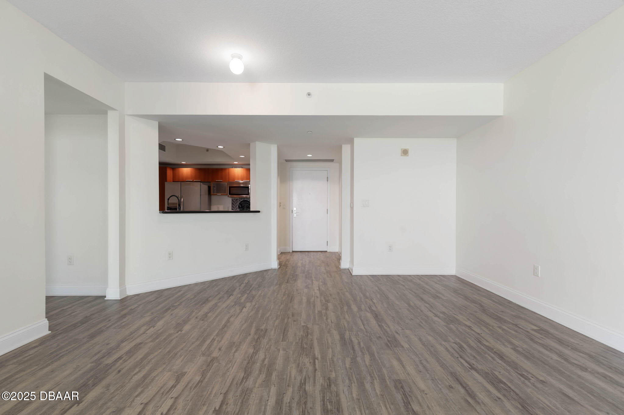 241 Riverside Drive, Unit 708 Holly Hill, FL 32117 - Photo 13 of 80 an empty room with wooden floor and mirror