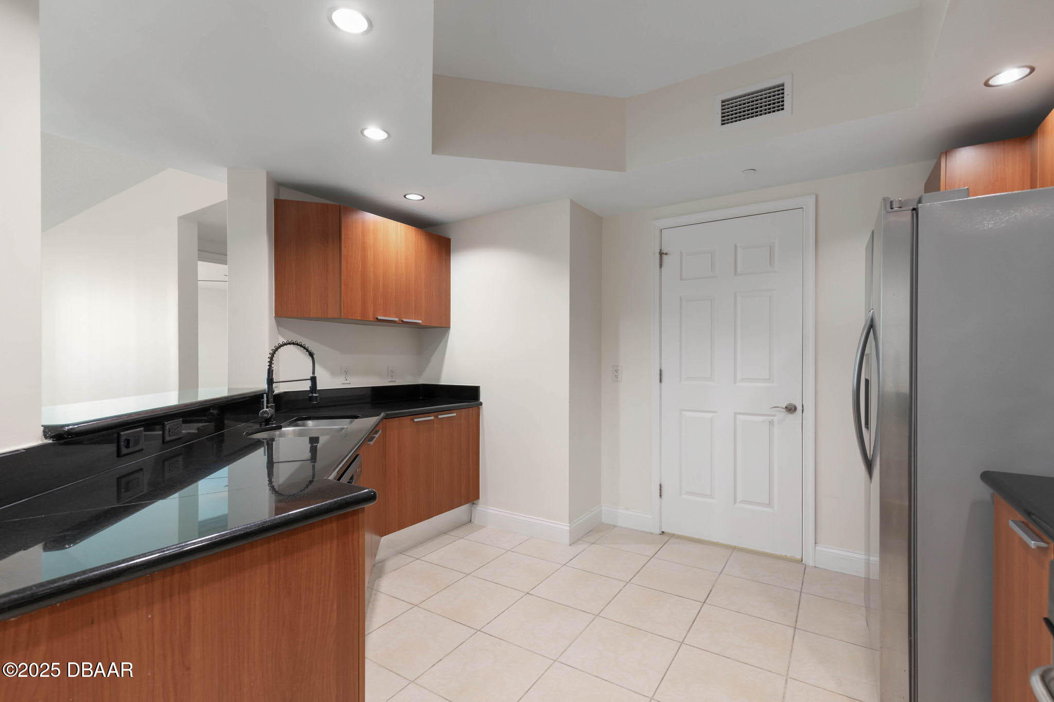 241 Riverside Drive, Unit 708 Holly Hill, FL 32117 - Photo 14 of 80 a kitchen with stainless steel appliances granite countertop a refrigerator and a sink