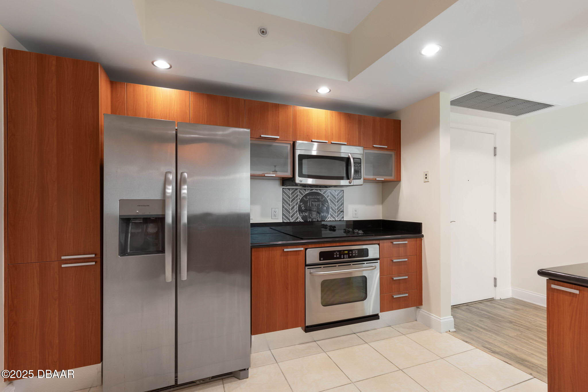 241 Riverside Drive, Unit 708 Holly Hill, FL 32117 - Photo 16 of 80 a kitchen with stainless steel appliances granite countertop a refrigerator a sink and a stove