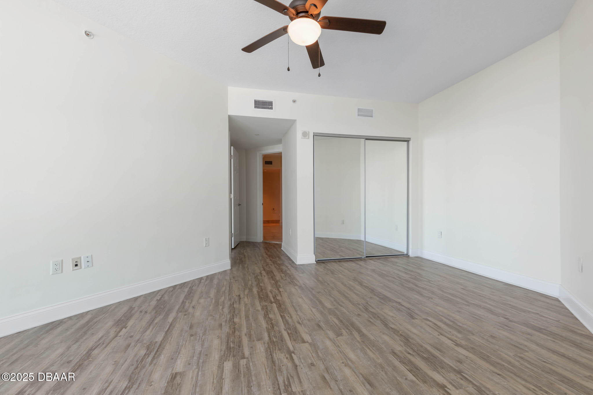 241 Riverside Drive, Unit 708 Holly Hill, FL 32117 - Photo 28 of 80 an empty room with wooden floor ceiling fan and windows