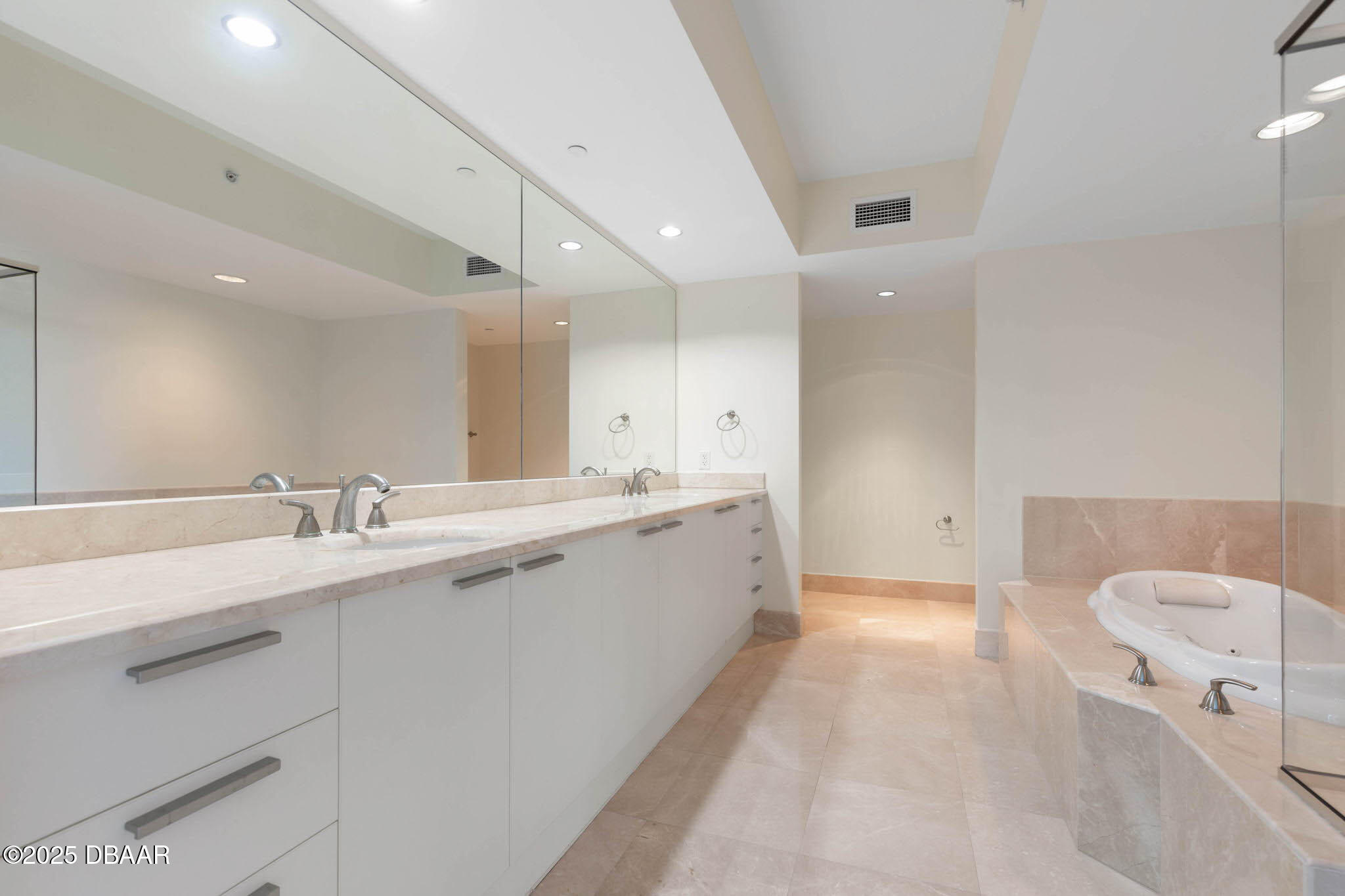 241 Riverside Drive, Unit 708 Holly Hill, FL 32117 - Photo 29 of 80 a large white bathroom with a sink a bathtub and a double vanity