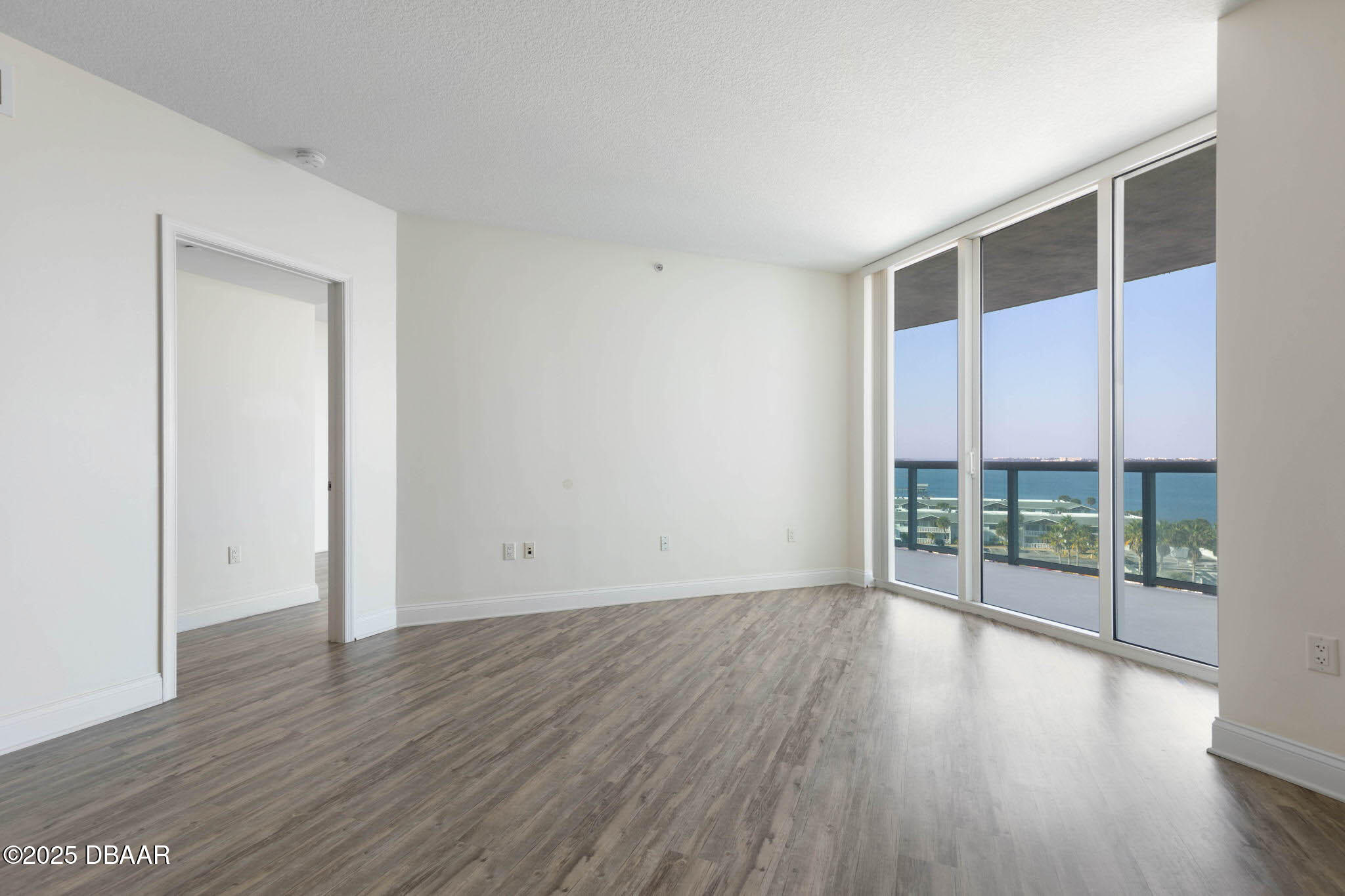 241 Riverside Drive, Unit 708 Holly Hill, FL 32117 - Photo 34 of 80 wooden floor in an empty room with a window