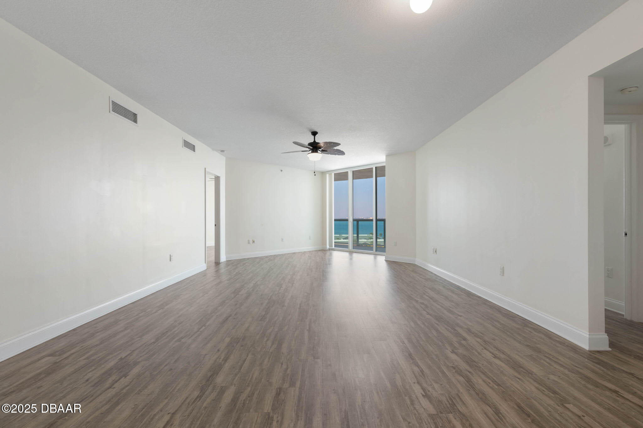241 Riverside Drive, Unit 708 Holly Hill, FL 32117 - Photo 36 of 80 a view of an empty room with wooden floor and a window