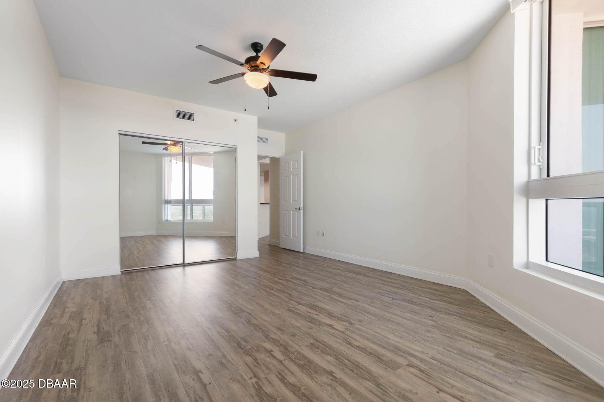 241 Riverside Drive, Unit 708 Holly Hill, FL 32117 - Photo 39 of 80 wooden floor in an empty room with a window
