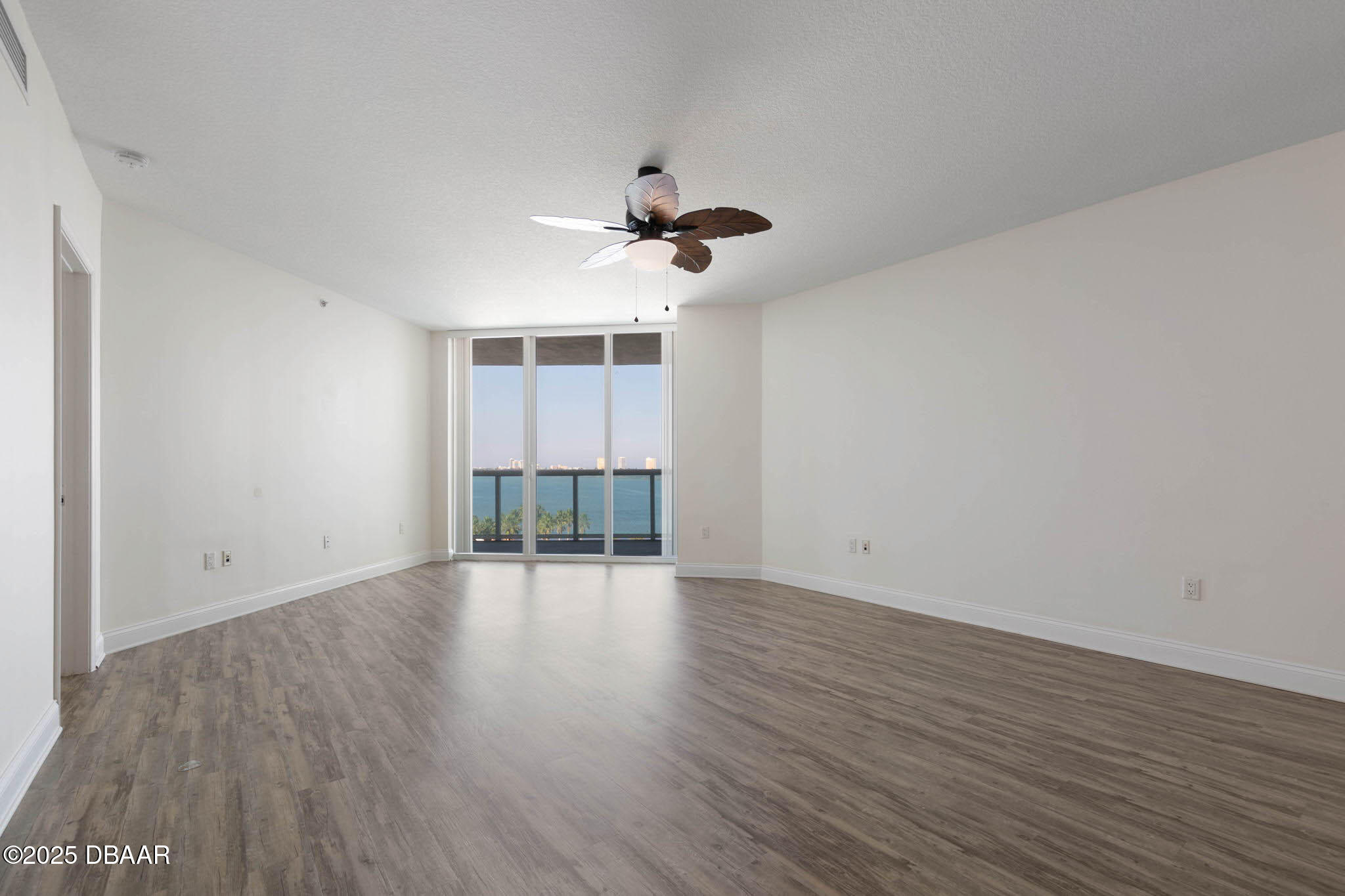 241 Riverside Drive, Unit 708 Holly Hill, FL 32117 - Photo 10 of 80 wooden floor in an empty room with a window