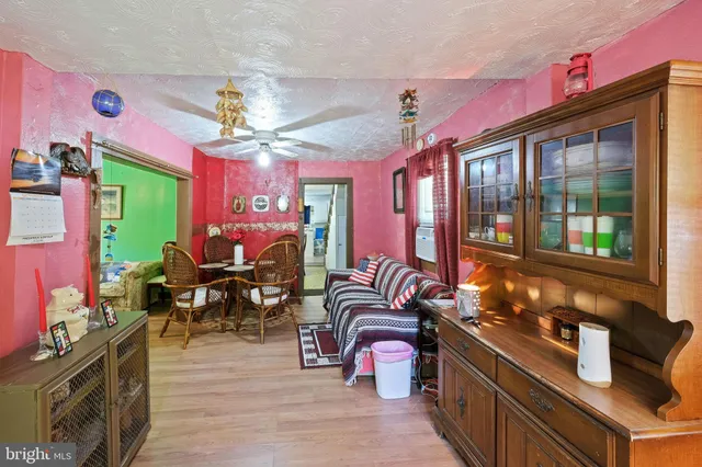 a kitchen with stainless steel appliances granite countertop a stove top oven a dining table and chairs with wooden floor