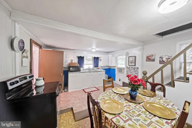 a view of a livingroom with furniture and staircase