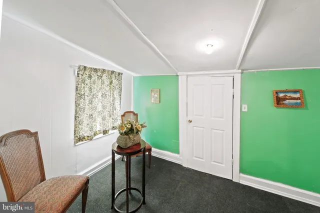 a spacious bedroom with a bed and a chandelier