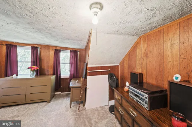 a bedroom with a bed and a mirror