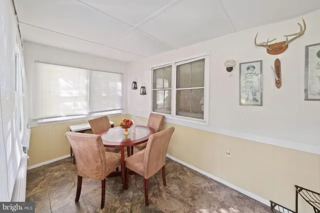 a dining room with furniture and window