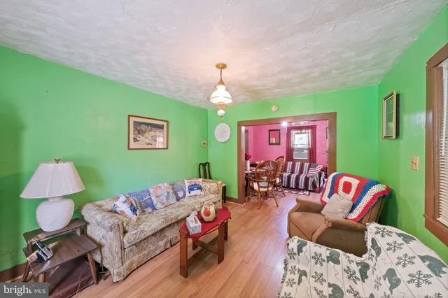 a living room with furniture and a chandelier