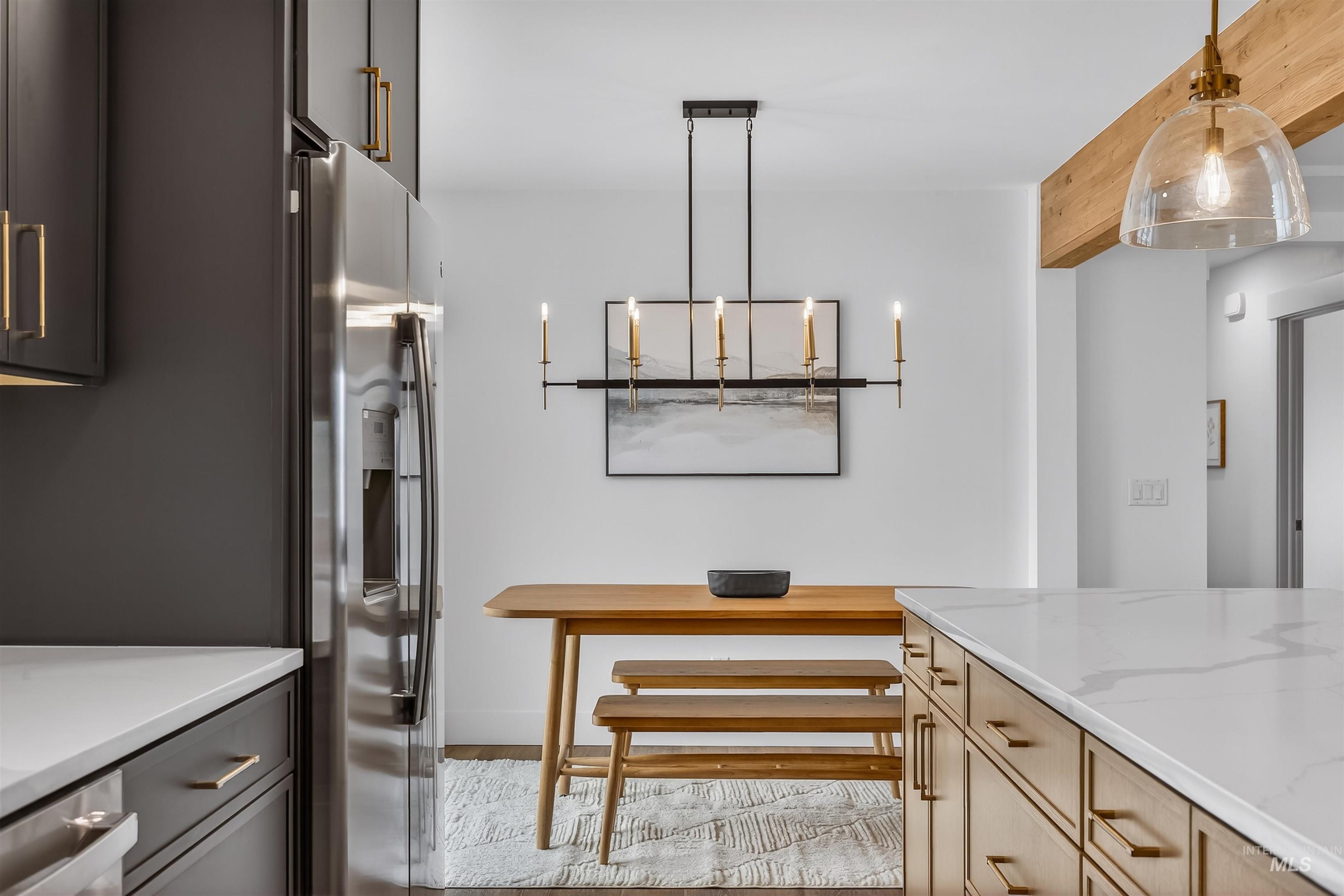 3513 8th Street Lewiston, ID 83501 - Photo 14 of 43 Kitchen featuring stainless steel fridge with ice dispenser, hanging light fixtures, and light stone counters