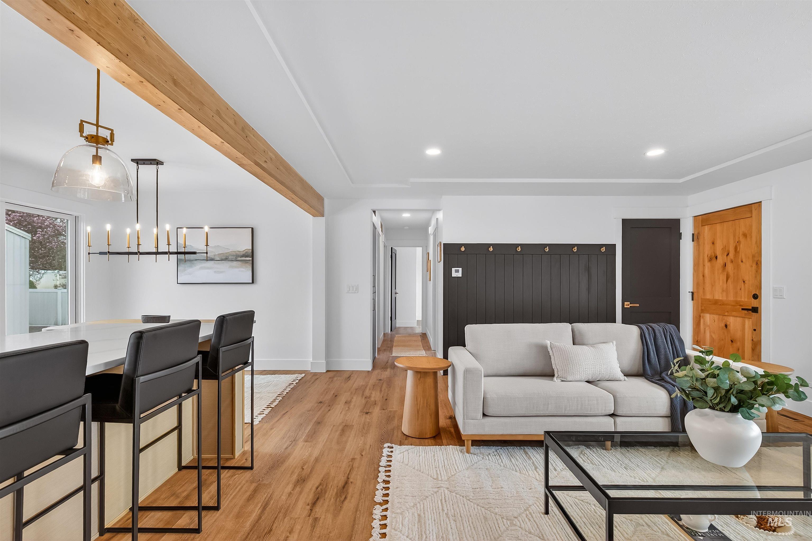 3513 8th Street Lewiston, ID 83501 - Photo 24 of 43 Living room featuring light wood-type flooring, beam ceiling, and a chandelier