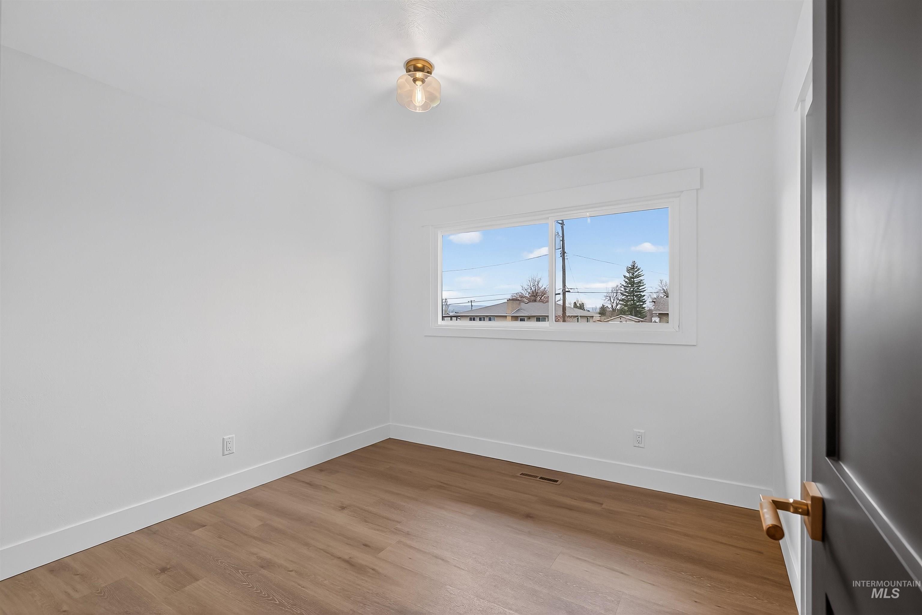 3513 8th Street Lewiston, ID 83501 - Photo 26 of 43 Empty room with baseboards and light wood-style flooring
