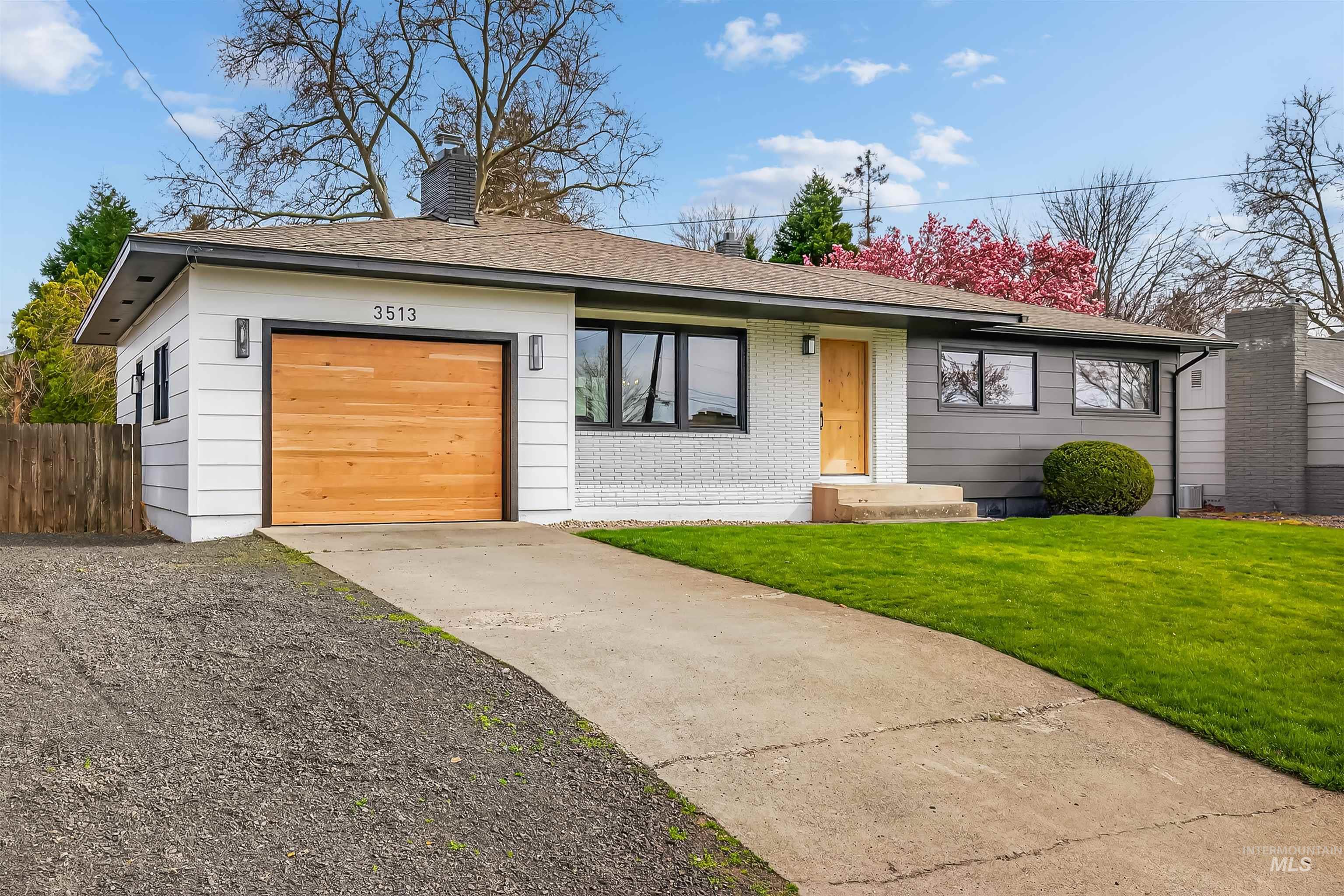 3513 8th Street Lewiston, ID 83501 - Photo 3 of 43 View of front of property featuring driveway, a garage, a shingled roof, a chimney, and brick siding