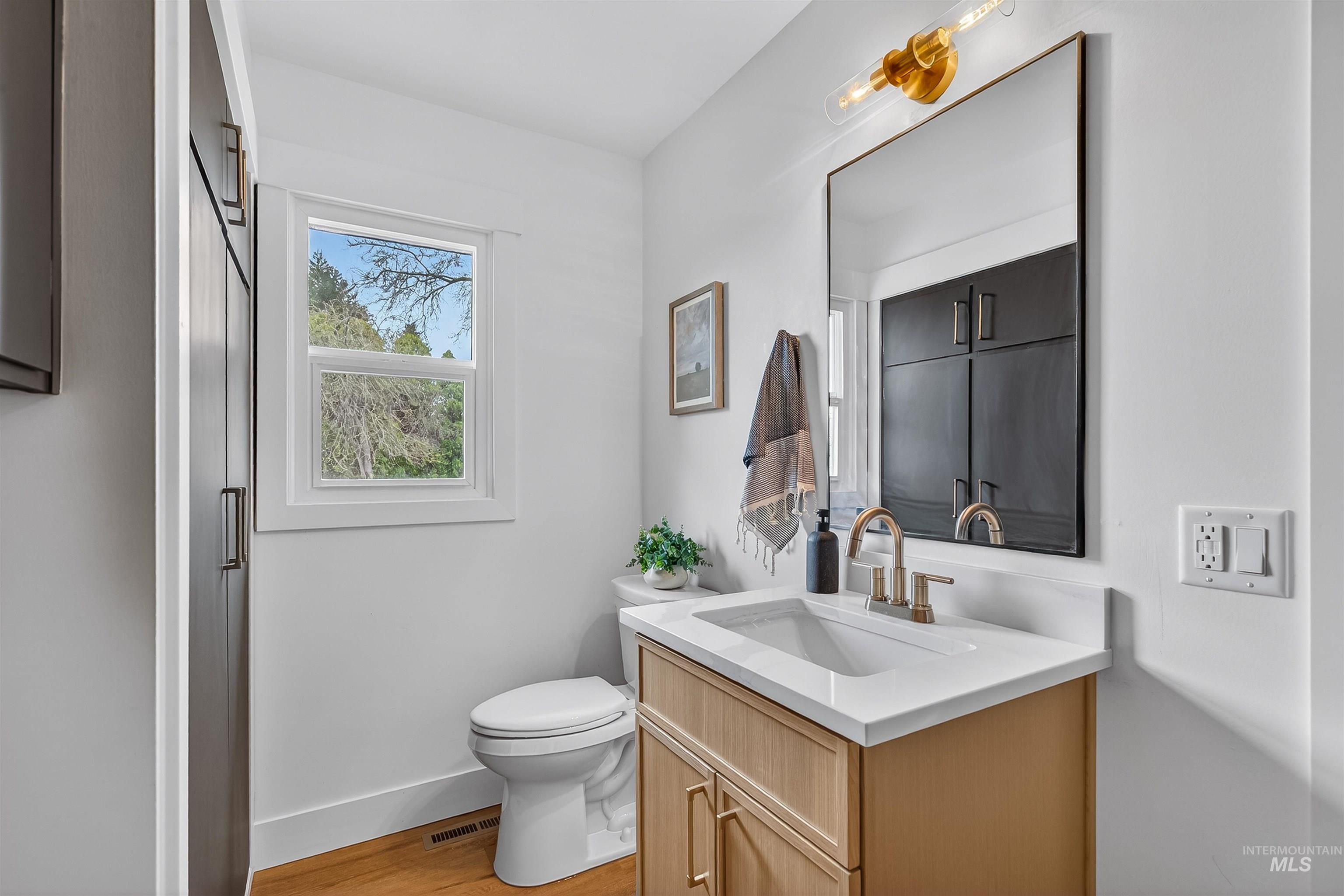 3513 8th Street Lewiston, ID 83501 - Photo 34 of 43 Half bathroom with vanity and light wood-style floors