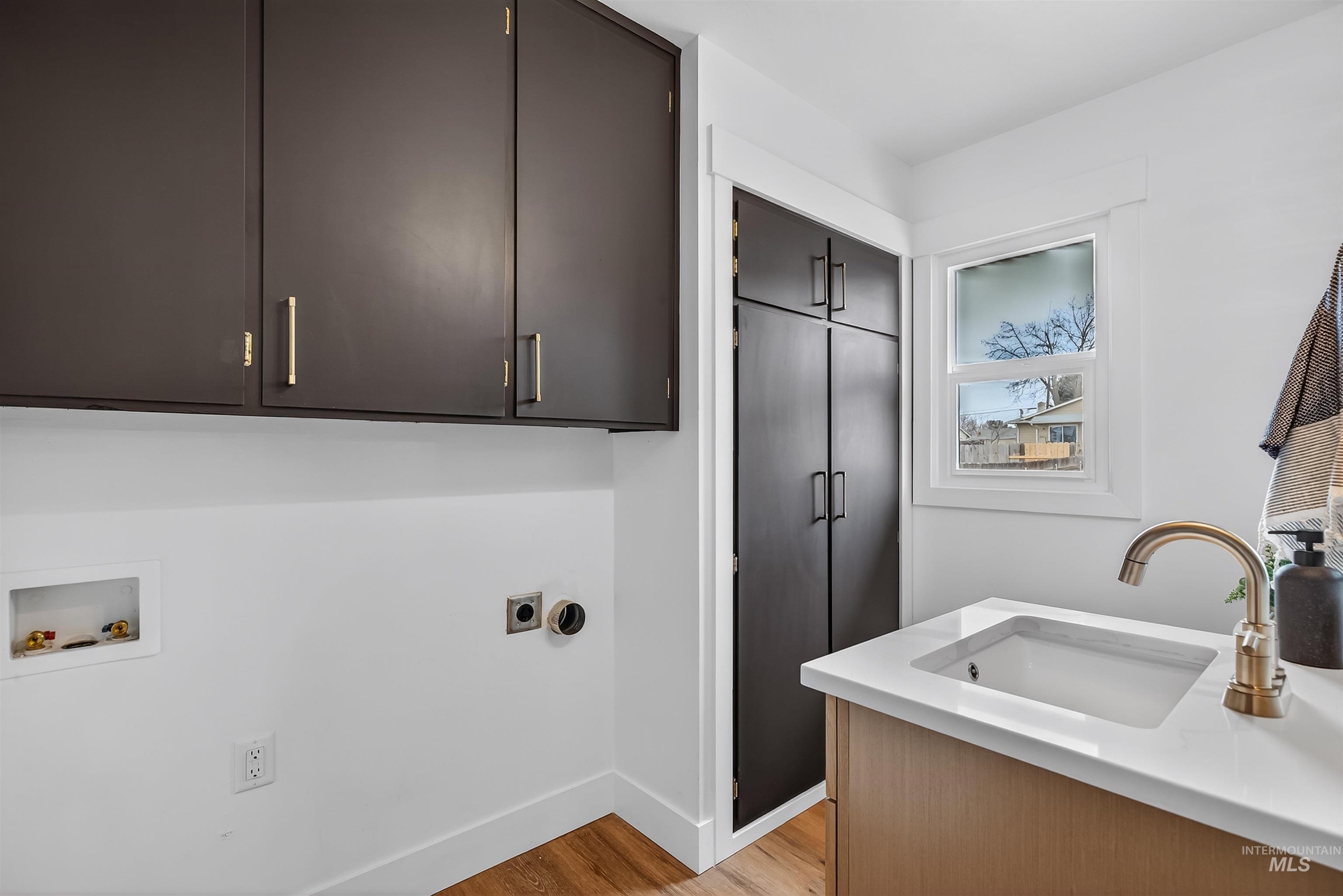 3513 8th Street Lewiston, ID 83501 - Photo 35 of 43 Laundry room with light wood finished floors, cabinet space, hookup for a washing machine, and hookup for an electric dryer