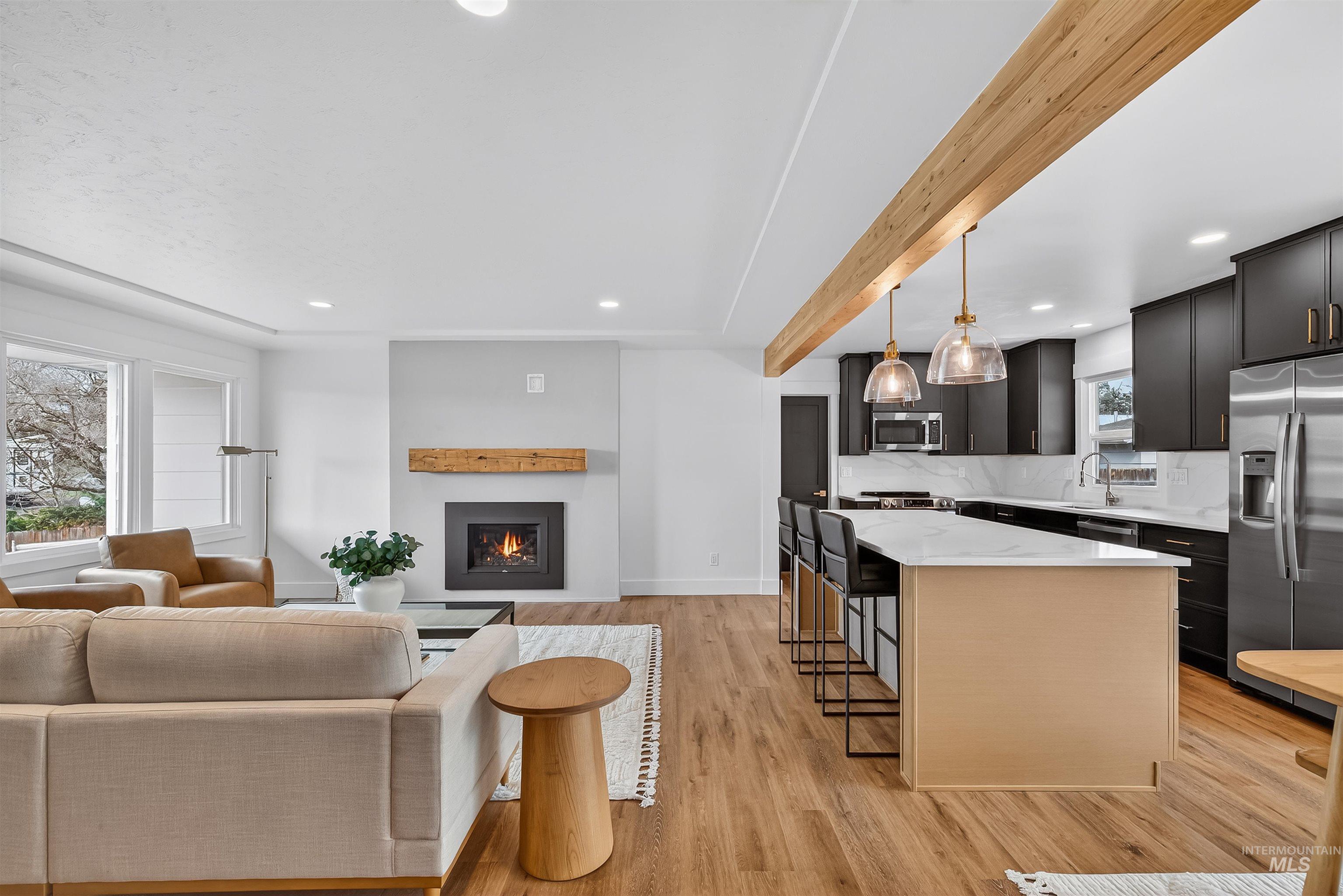 3513 8th Street Lewiston, ID 83501 - Photo 42 of 43 Kitchen with open floor plan, a kitchen island, dark cabinets, a kitchen breakfast bar, and stainless steel appliances