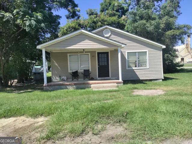 a front view of a house with a yard