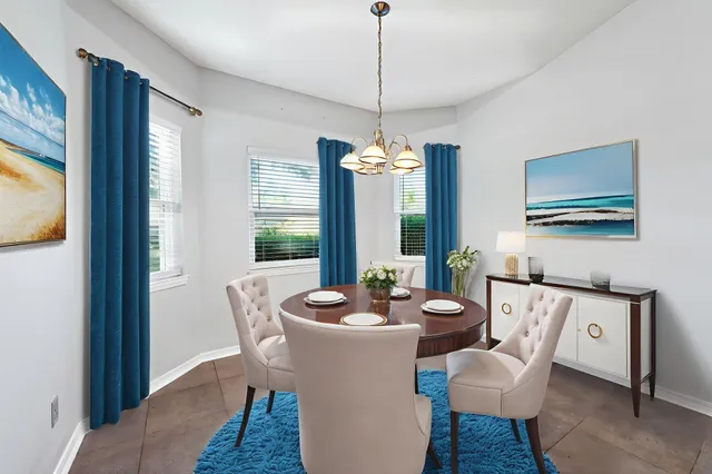 a dining room with furniture a chandelier and wooden floor