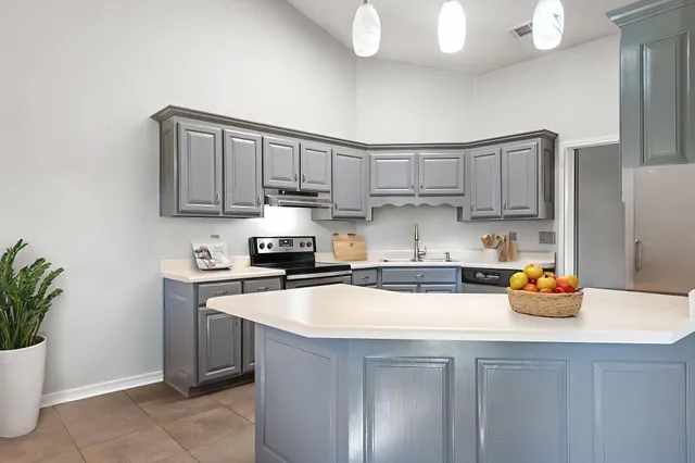 a kitchen with a sink a stove and cabinets