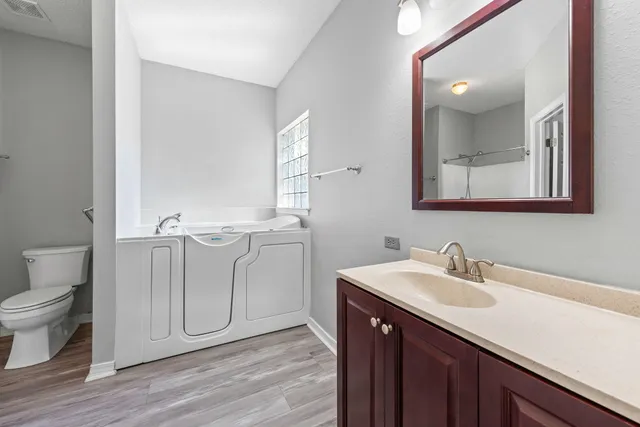 a bathroom with a sink toilet and mirror