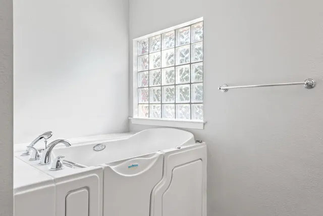 a bathroom with a sink and a window