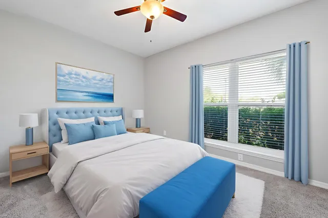 a bedroom with a large bed and a large window