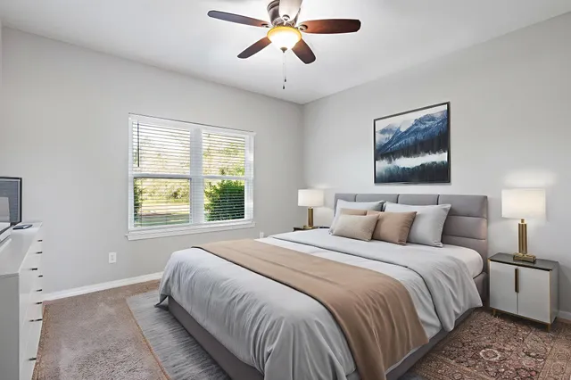 a bedroom with a bed and a painting on the wall