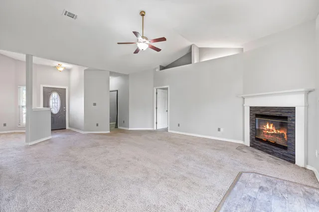 a view of an empty room with a fireplace