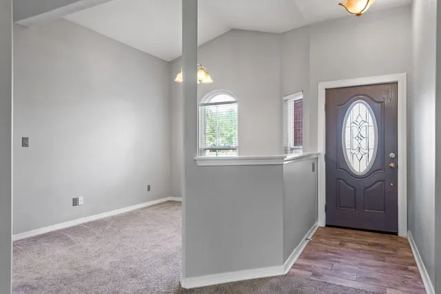 an empty room with window and wooden floor